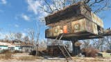 An intricate tree house has been constructed atop a large tree. There are some rickety stairs leading up to a red front door.