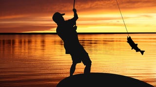 A photo of a person fishing at sundown. They're silhouetted against a golden, sun-setting horizon, and leaning back having caught a fish on their line.